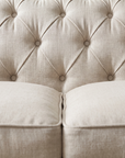 Macro of the deep diamond button tufting where the back meets the seat cushions