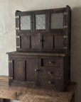 Antique Hoosier Bakers Cabinet three-quarter view from the left on a reclaimed wood table