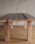 End view of the redwood dining table showing the separate planks and square legs