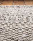 Close-up of the chunky hand-spun Criolla wool Soga weave on the Awanay rug
