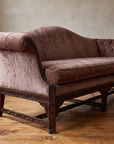 Low angle along the sofa from the high pleated scroll arm