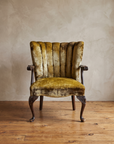 Front view of the chartreuse velvet channel-back armchair with carved cabriole legs