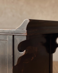 Detail of the upturned top end and carved cloud-scroll brackets