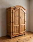 Three-quarter view of the armoire showing paneled side and depth