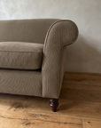 Detail of the scroll arm and fine pinstripe fabric