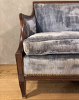Close-up of the mahogany arm, brass nailheads and reeded leg