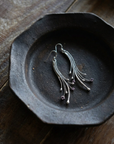 Amethyst Comet Earrings on black ceramic dish