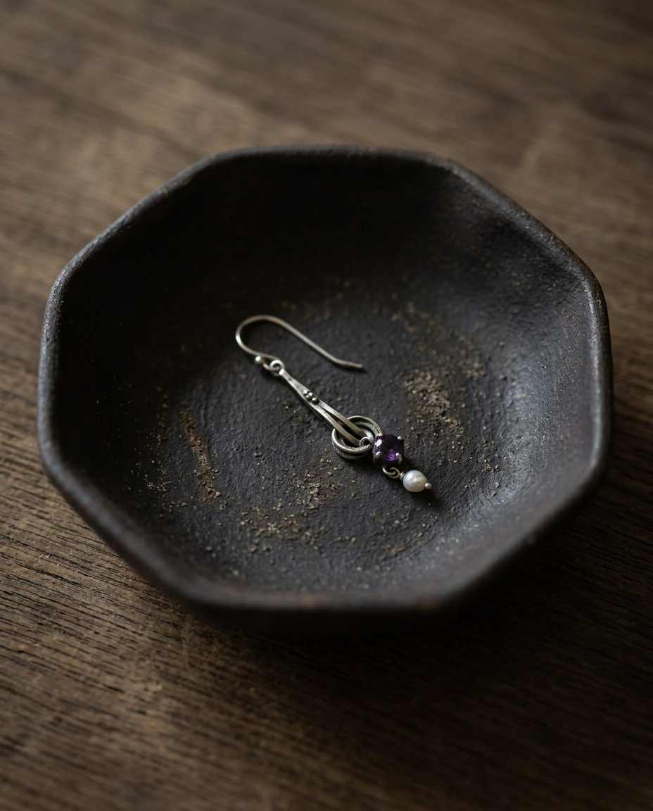 Amethyst and Pearl Drop Earring on black ceramic dish
