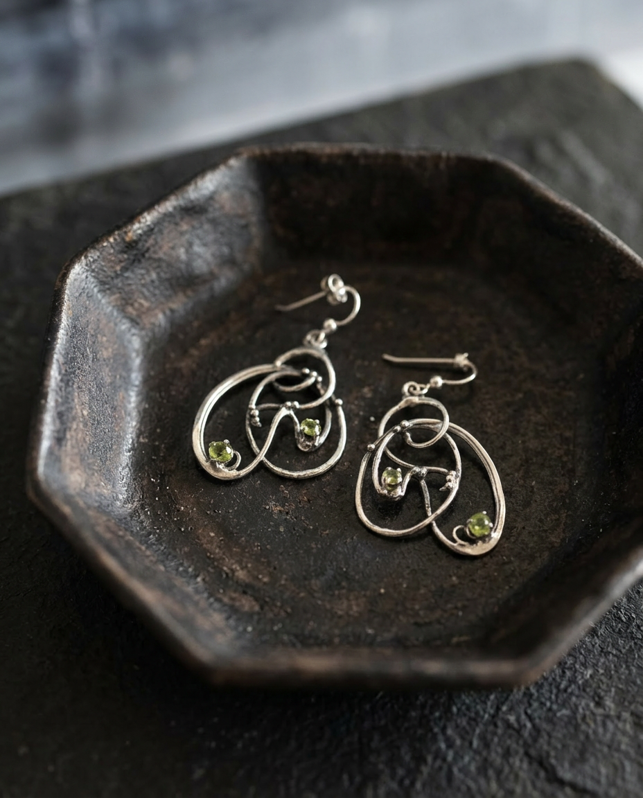 Peridot Scribble Earrings on black ceramic dish