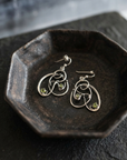 Peridot Scribble Earrings on black ceramic dish