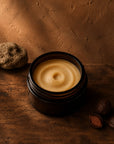 Kokum whipped body butter in an amber jar with raw kokum nuts