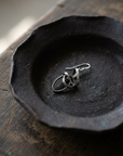 Open Loop Wire Earring on black ceramic dish