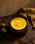 Golden Karite whipped body butter in an amber jar with shea nuts