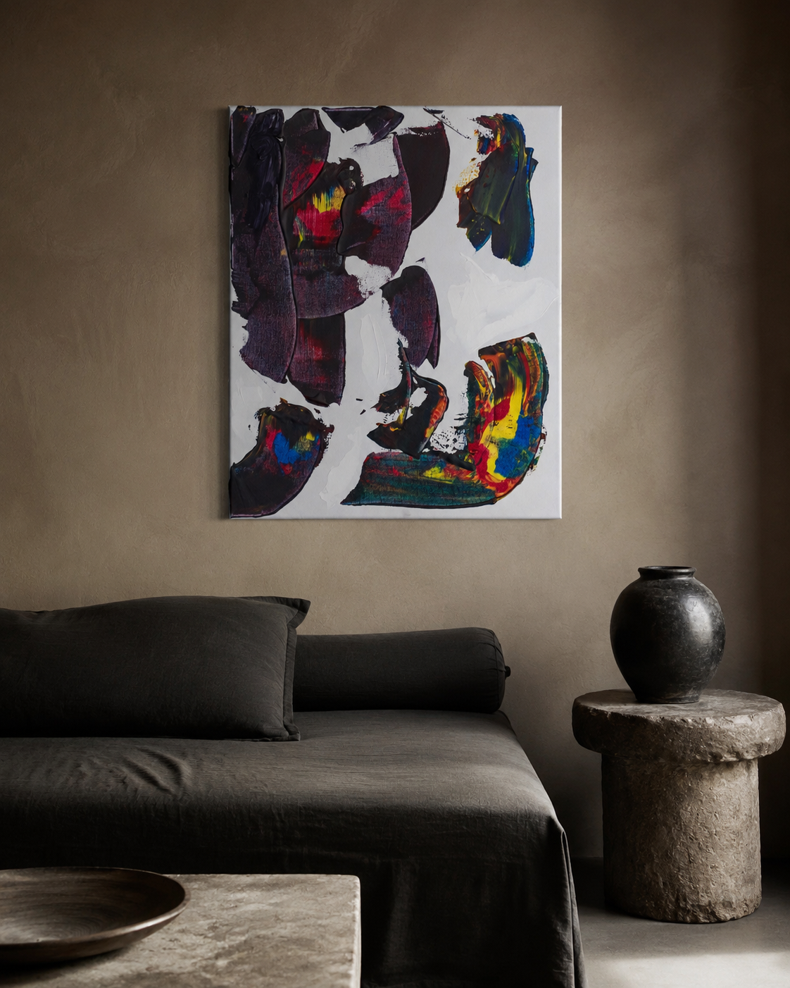 This Time 1 hung above a dark linen daybed in a warm plaster room