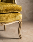 Macro detail of the front cabriole leg and apron carving on The Citron Bergère chair