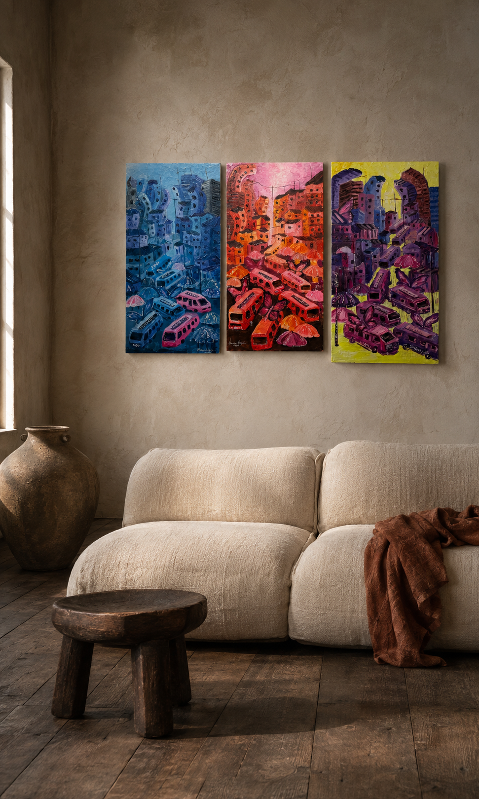 Three panel painting in blue, red and violet hung above a linen sofa in a warm plaster room