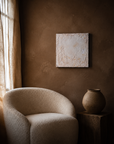 Sanctuary 1 hung above a boucle chair in a warm plaster room