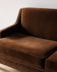 Detail of the cognac velvet arm and seat cushion with piped welting