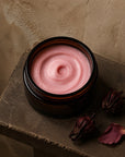 Sorrel Rose whipped body butter in an amber jar with dried hibiscus