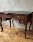 Antique writing desk, three-quarter angle view
