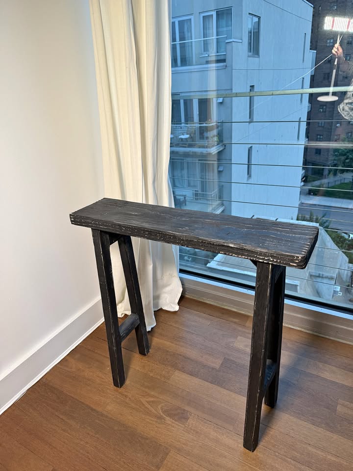 Ebonized reclaimed wood console, angled view showing leg splay