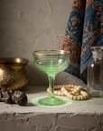 Gold-Rim Swirl Coupe, uranium glass, styled with brass vessel and block-print textile