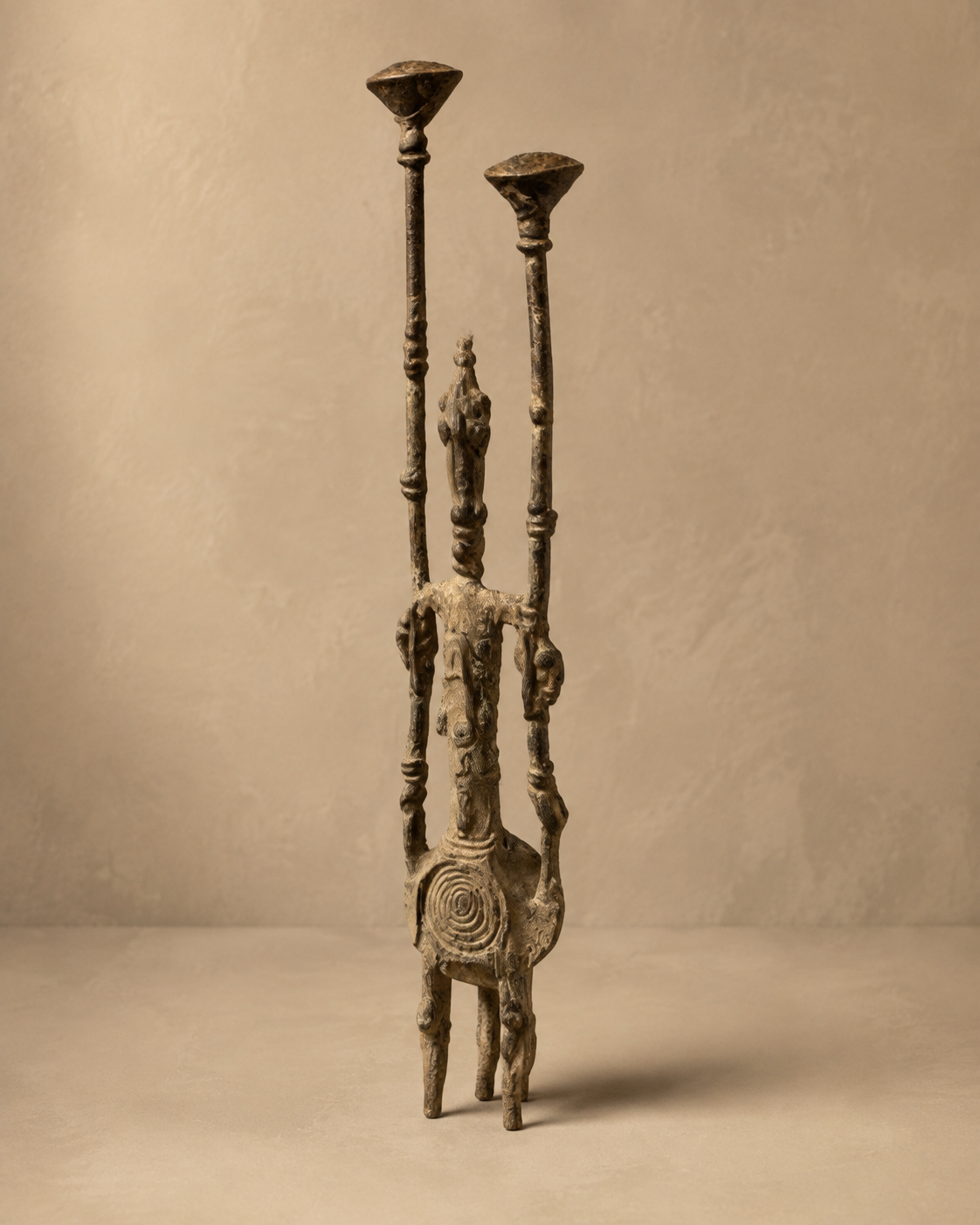 African Metal Figure, hand-forged standing figure with two tall candle-cup stems and spiral detail
