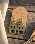 Gye W'Ani Adinkra earrings in olive green by The Ariana Collective, on a kraft tag