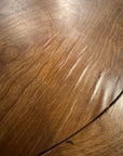 Real condition photo of the Aurelia tabletop showing small areas of lifting veneer near the inset banding