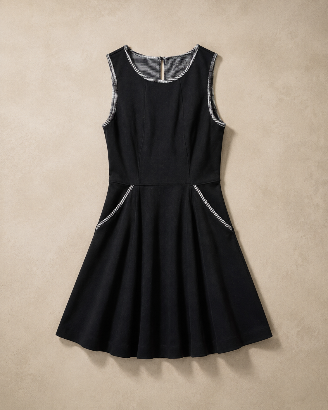 Black Striped Trim Dress laid flat, sleeveless black fit and flare with gray striped trim