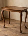 Three-quarter view of the burl walnut side table with cabriole legs