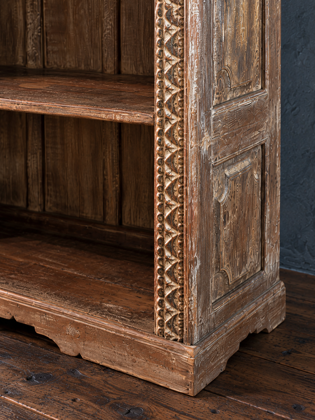 Paneled bookcase side and shaped plinth base.