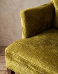 Chartreuse velvet diamond-tufted armchair, high top-down angle where arm meets seat cushion and waterfall front edge