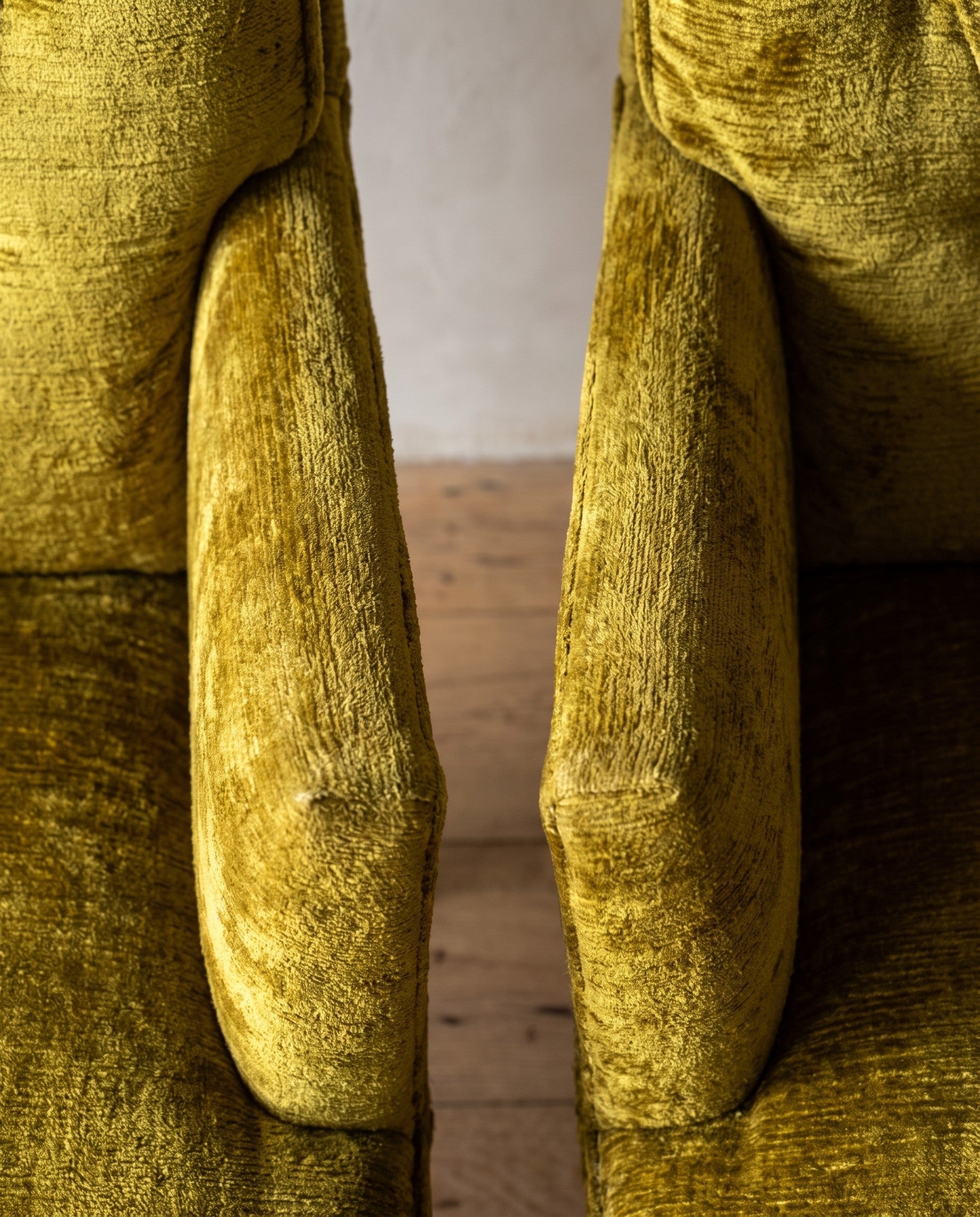 Chartreuse velvet diamond-tufted armchair, overhead macro looking down both arm rails