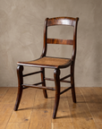 Antique cane seat side chair, three-quarter angle view
