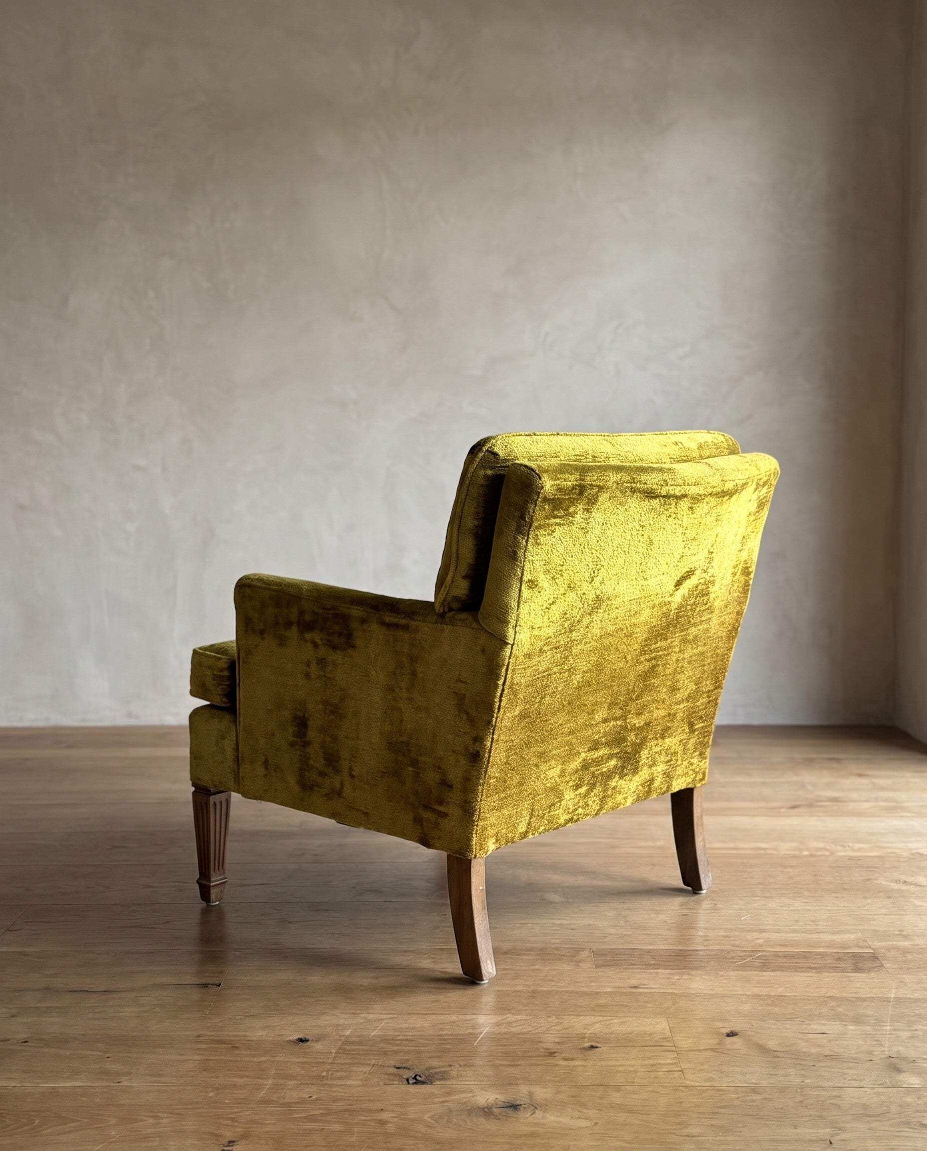 Chartreuse velvet diamond-tufted armchair, rear three-quarter view showing back of tufted cushion and all four legs