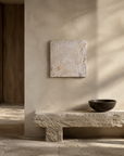 Sanctuary 2 hung above a stone bench in a warm plaster room
