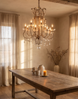 The chandelier hanging over a long oak dining table, full scale in a warm interior