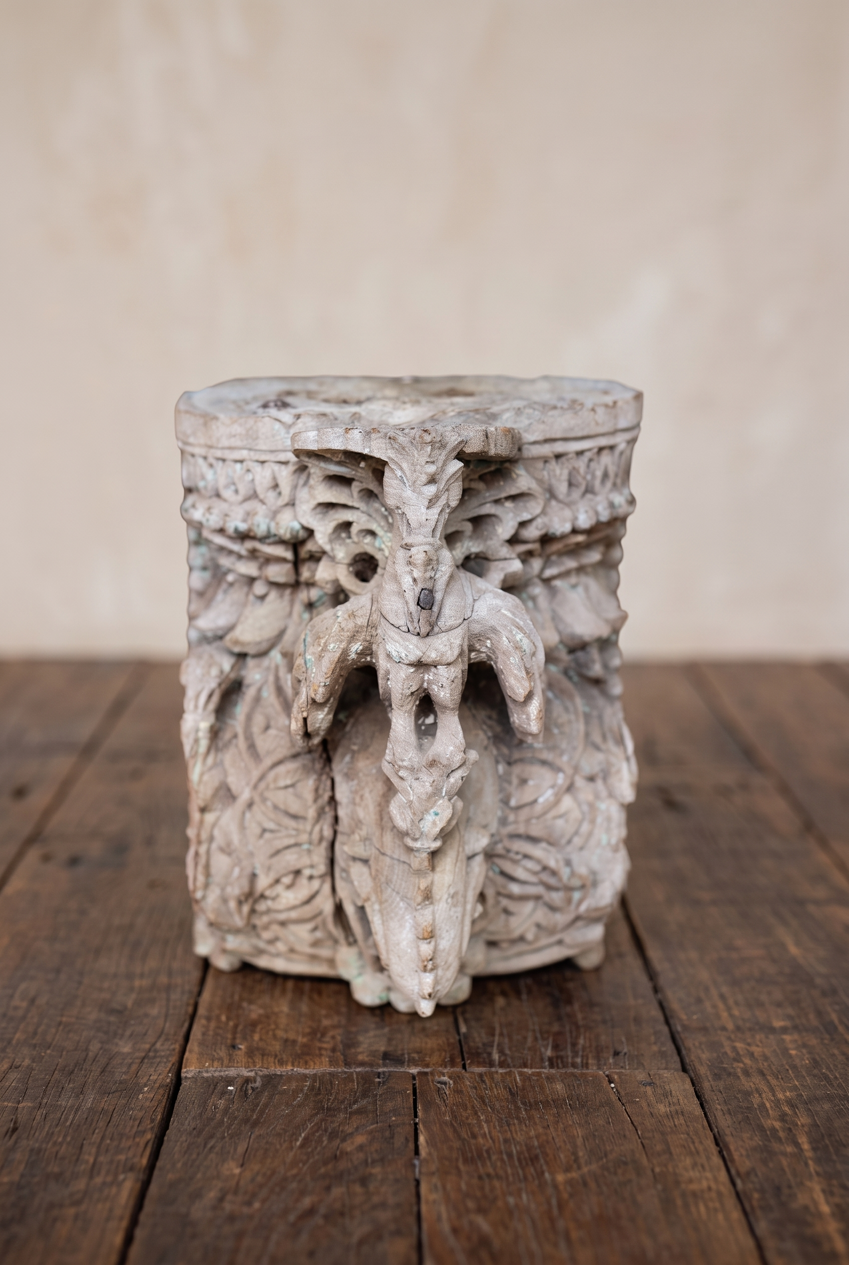 Carved teak temple capital, front detail of a central parrot figure