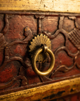 Detail of an aged brass ring pull on a fluted fan backplate