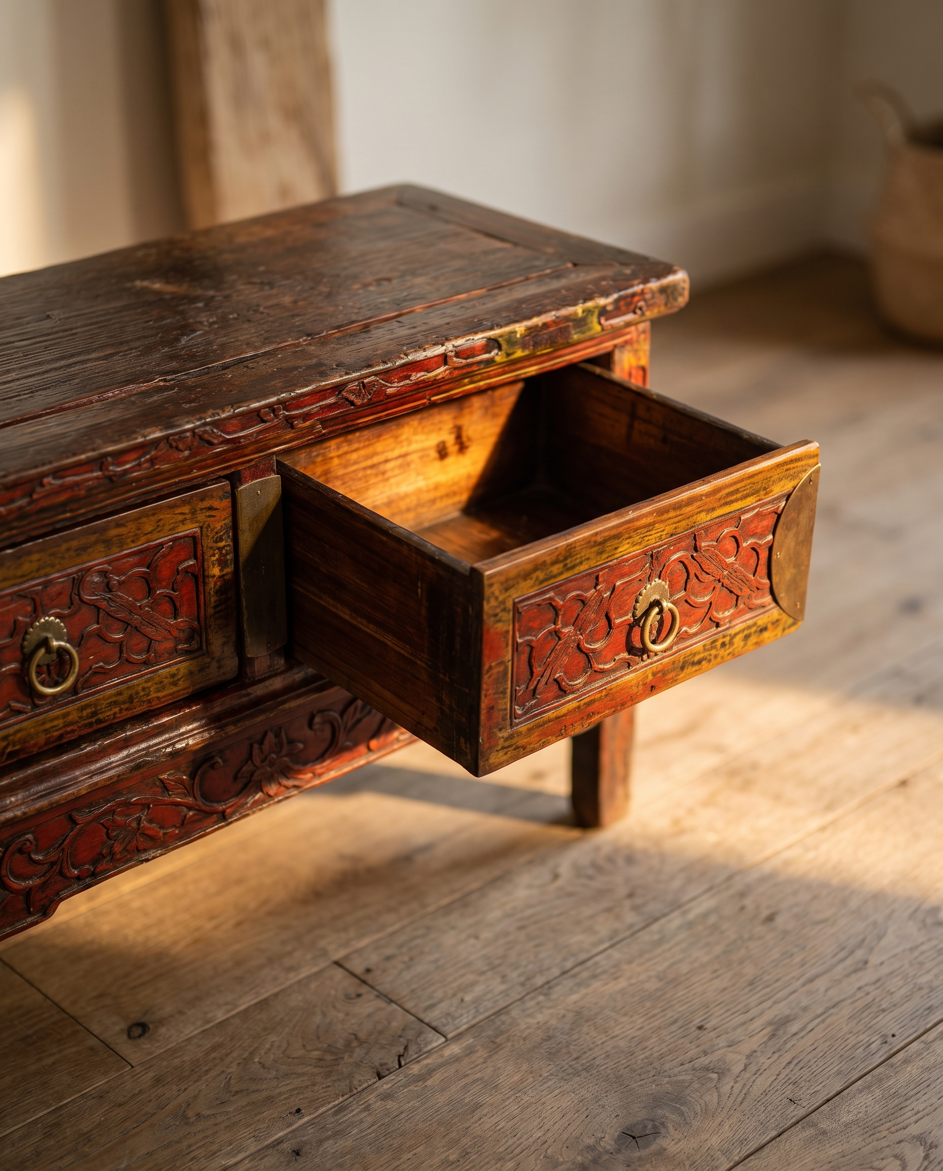 A drawer pulled open, showing the honest aged-wood interior