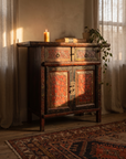 The Vermilion Garden Cabinet in a warm candlelit room