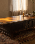 Antique low table, wider room view with plant and kilim rug