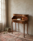 Writing desk styled with a letter, fountain pen, and lit candle
