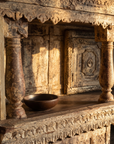 Detail of the upper display shelf with turned columns and scalloped valance