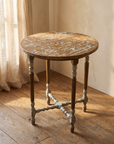 Three-quarter view of the round distressed-top accent table with fluted legs