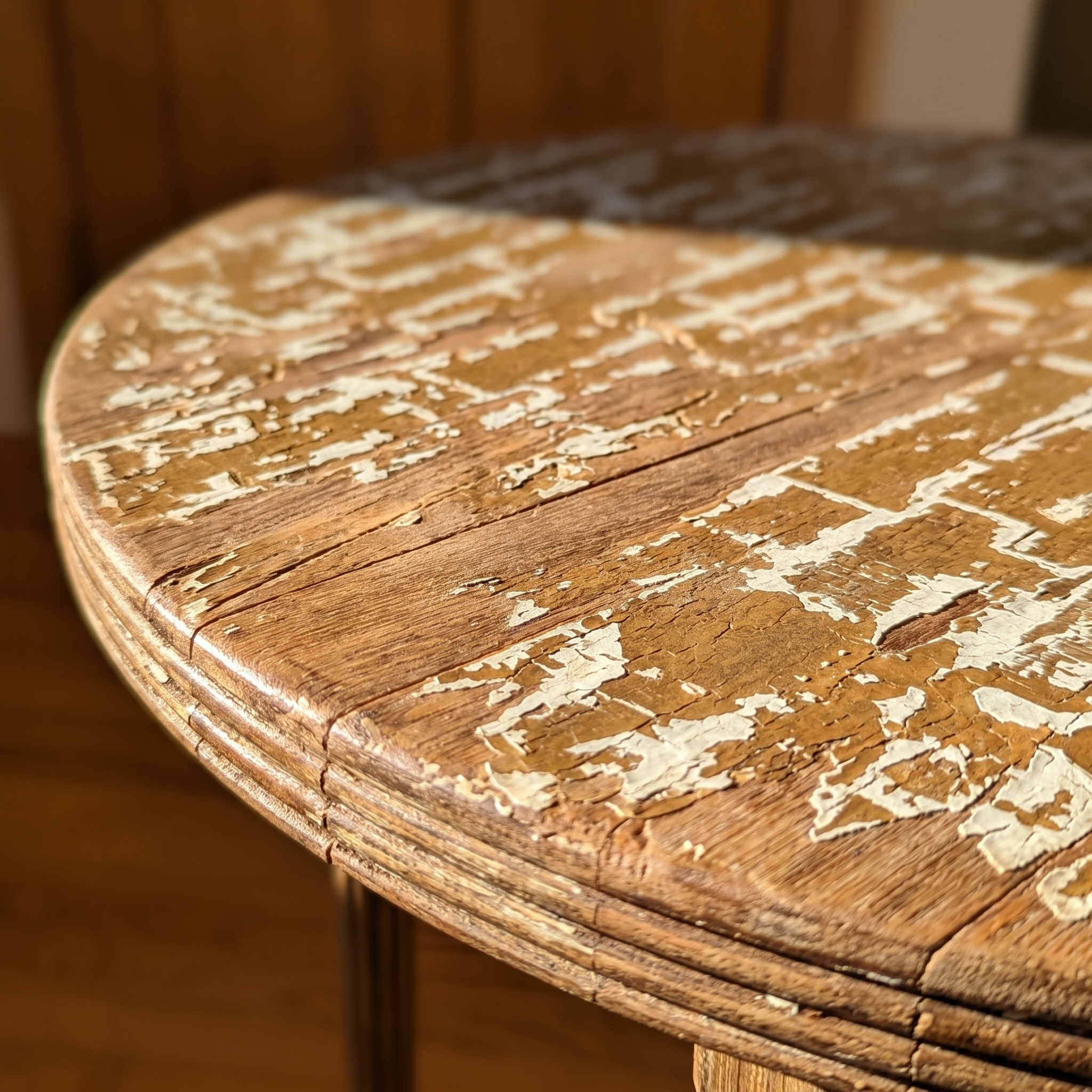 Macro of the crackled ivory-over-wood patina on the tabletop