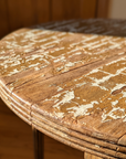 Macro of the crackled ivory-over-wood patina on the tabletop