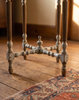 Base detail: fluted legs, X-stretcher with central finial, turned feet