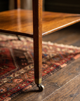 Detail of tapered mahogany leg with brass cap and caster